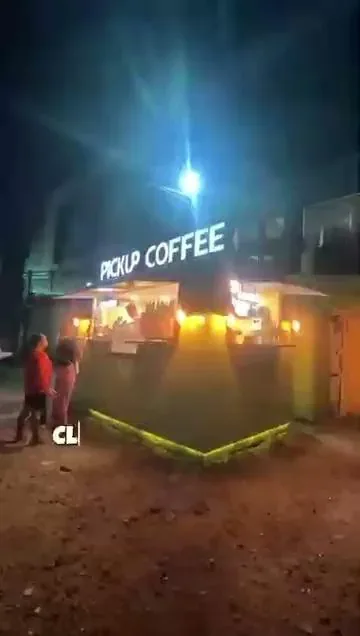 The Pickup Coffee outdoor stand lit up at night, the other merchant a Novaluxia PH points voucher redeems at