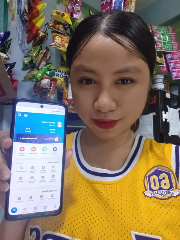 A user inside a store holding up a phone showing the Novaluxia app